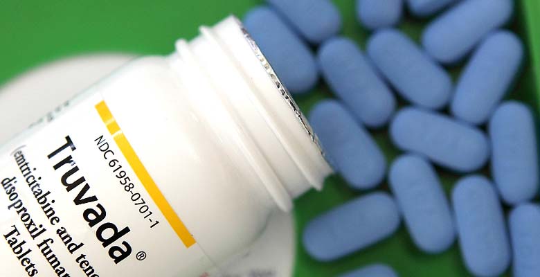 Pill bottle labeled Truvada, with blue Truvada pills. Truvada is a drug used to prevent the contraction of HIV. 