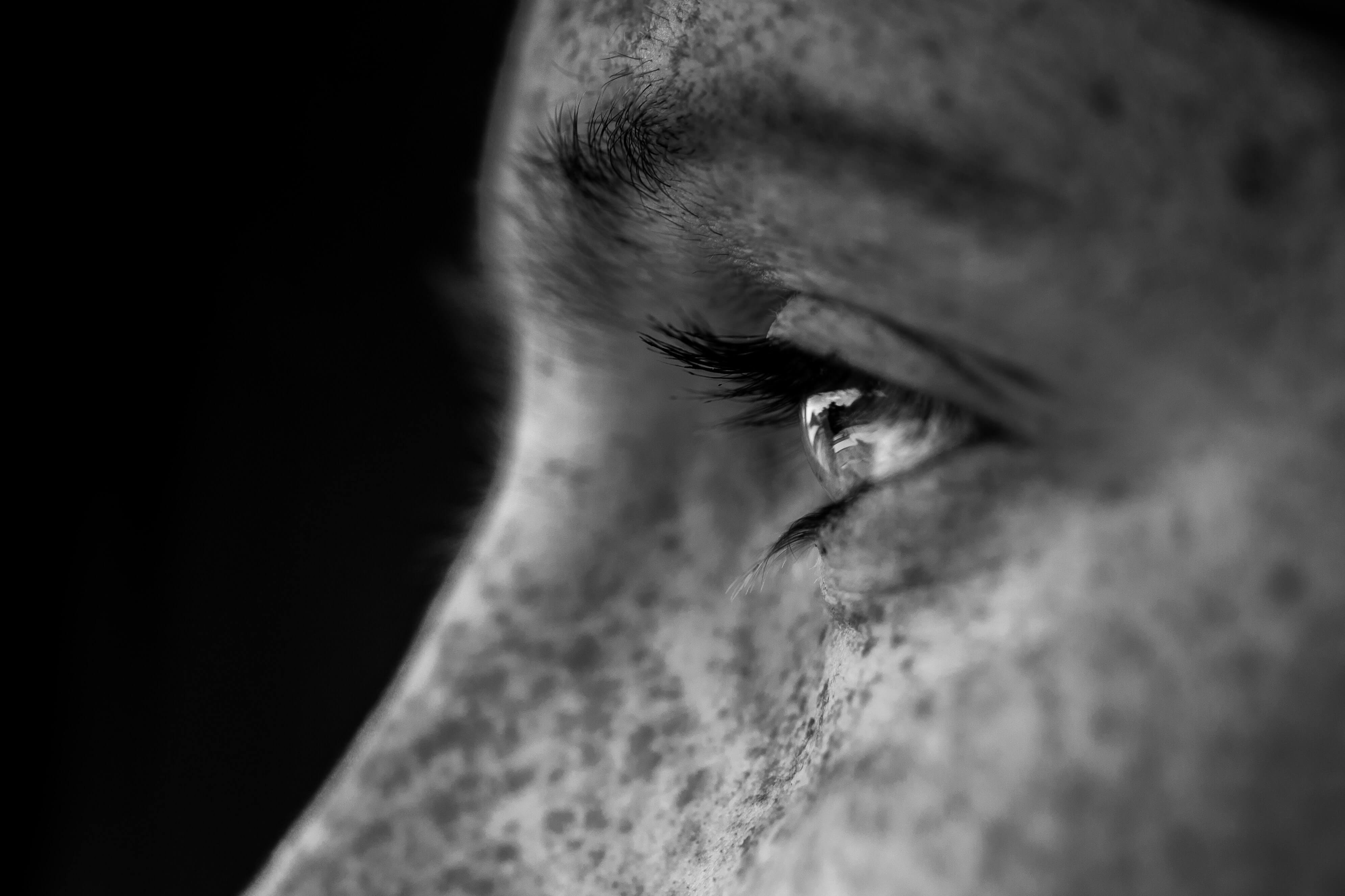 close up of man's eye and face with freckles